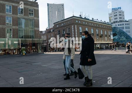 Vita quotidiana nella città di Eindhoven nei Paesi Bassi con persone che indossano maschere facciali mentre sono fuori a piedi o in bicicletta, utilizzando il facemask come misura protettiva contro la diffusione della pandemia di Coronavirus Covid-19. Paesi Bassi da martedì 13 ottobre 2020, quando il primo ministro olandese Mark Rutte ha annunciato che il paese va in una chiusura parziale, la chiusura dei bar e ristoranti, l'uso obbligatorio di maschera facciale al chiuso, la limitazione al numero di persone che si riuniscono al chiuso, attività sportive e altro ancora sono interessati. Il paese è stato uno dei principali focolai in Europa. Eind Foto Stock