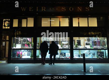 Persone che controllano la vetrina della gioielleria Weir and Sons, nel centro di Dublino. Sabato 14 novembre 2020 a Dublino, Irlanda. (Foto di Artur Widak/NurPhoto) Foto Stock