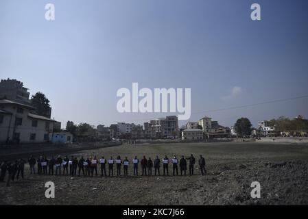 Un gruppo di attivisti del patrimonio ha messo in scena una protesta simbolica insieme a cartelli contro la costruzione di strutture in cemento intorno al secolare laghetto Kamalpokhari a Kathmandu, Nepal, venerdì 15 gennaio 2021. Kamalpokhari stagno è asciugato per la costruzione di strutture in cemento intorno. (Foto di Narayan Maharjan/NurPhoto) Foto Stock