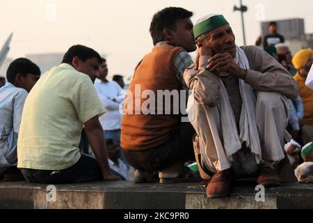 Un agricoltore fuma un bidi, o tabacco arrotolato a mano, mentre bloccano una strada principale in protesta contro le nuove leggi agricole al confine di stato Delhi-Utttar Pradesh vicino Ghazipur, alla periferia di Nuova Delhi, India il 21 febbraio 2021. (Foto di Mayank Makhija/NurPhoto) Foto Stock