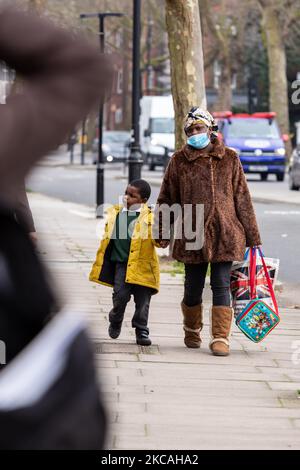 Una madre prende un figlio dopo il primo giorno a scuola nel sud di Londra mentre le scuole in Inghilterra riaprono il 8 marzo 2021. L'apertura delle scuole è un primo passo della mappa stradale di PM Boris Johnson che gradualmente solleverà tutte le restrizioni di blocco di Coronavirus. (Foto di Dominika Zarzycka/NurPhoto) Foto Stock