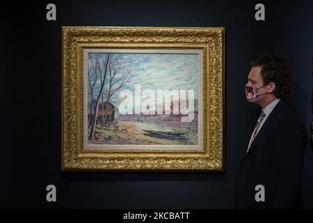 LONDRA, REGNO UNITO - 22 MARZO 2021: Un membro dello staff guarda a le chantier de Matrat à Moret sur Loing (1889) di Alfred Sisley (1839-1899), stima: £550.000 - 750.000 durante un invito fotografico per la settimana del 20/21° secolo di Bonhams, una serie di aste che celebrano gli ultimi cento anni di arte, il 22 marzo 2021 a Londra, Inghilterra. (Foto di Wiktor Szymanowicz/NurPhoto) Foto Stock