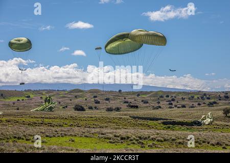 Le forze aeree statunitensi C-130s conducono un airdrop nei campi di addestramento di Pohakulua, Hawaii, 1 novembre 2022. Joint Pacific Multinational Readiness Center 23-01 è una rotazione di formazione realistica ci permette di provare il movimento strategico, e addestrare in ambienti e condizioni uniche in cui è più probabile che siano impiegati in caso di crisi o di conflitto.(Stati Uniti Foto dell'esercito di PFC. Mariah Aguilar, 25th° divisione fanteria) Foto Stock