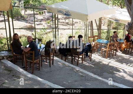 Il 13 maggio 2021 gli ospiti si siedono in una caffetteria nel quartiere Anafiotika di Atene, in Grecia. (Foto di Nikolas Kokovlis/NurPhoto) Foto Stock