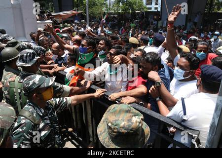 Il personale paramilitare è in guardia all'ingresso dell'ufficio dell'Ufficio Centrale d'inchiesta (CBI), mentre i sostenitori del Trinamool Congress (TMC) gridano slogan dopo che il CBI ha arrestato quattro leader del Trinamool Congress (TMC) in relazione al caso dell'operazione di sting Narada del 2016, a Kolkata il 17 maggio 2021. (Foto di Debajyoti Chakraborty/NurPhoto) Foto Stock