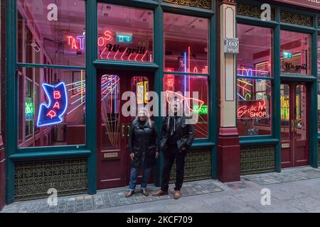 LONDRA, REGNO UNITO - 25 MAGGIO 2021: I neon maker e designer Linda e Marcus Bracey (L-R) di Gods Own Junkyard posano accanto a un'installazione caratterizzata da insegne e neon del film Judge Dredd creato da Chris Bracey durante un invito fotografico per la mostra 'Electric City' al Leadenhall Market, il 25 maggio 2021 a Londra, Inghilterra. La collaborazione di Gods Own Junkyard's e Leadenhall Market 'Electric City' (26th maggio – sabato 31st luglio 2021) è una coinvolgente mostra di neon e set-pieces realizzati per il film, tra cui le opere di insegne di Stanley Kubrick's Eyes Wide Shut, Judge Dredd, Batman, Foto Stock