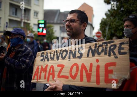 Un protester tiene un cartello con la scritta 'Let's US Save our Amazonia'. Diverse associazioni, partiti politici e persone si sono unite in un collettivo 'Touche pas a ma foret' (vale a dire 'non toccare la mia foresta') dimostrato a Lannemezan (Hautes-Pyrenees) come hanno voluto mostrare la loro opposizione ad una società globale, Florian. Marciarono dalla stazione ferroviaria di Lannemezan al municipio prima di stabilire un campo a Nestie. La società di segheria Florian vuole costruire una segheria gigante vicino alla città dei Pirenei di Lannemezan. La segheria dovrebbe trattare ogni anno circa 400,000 metri cubi di legno di faggio. Per questo Foto Stock