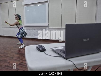 Un istruttore di Zumba conduce un corso di fitness di gruppo in streaming live su Zoom presso gli studi Effe di Bogor, Indonesia, il 11 luglio 2021. Zumba Fitness è un allenamento cardio non-stop che combina pilates in piedi, pugilato e danza. (Foto di Adriana Adie/NurPhoto) Foto Stock