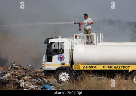 Forze antincendio che combattono gli incendi boschivi nei pressi di Salonicco. Le forze antincendio comprendono vigili del fuoco, veicoli dei vigili del fuoco, lavoratori municipali, Volontari e un elicottero che fa cadere l'acqua sopra il fuoco sulle colline con cespugli e immondizia luogo di scarico illegale vicino alla zona industriale di Salonicco e la zona residenziale vicino all'insediamento di Diavata e il villaggio di Neochorodouda in Oreokastro e Delta comune assistere la forza di terra a. estinguere l'incendio. Un'azienda di commercio di automobile è stata bruciata con le automobili. La Grecia sta avendo molti incendi, incendi boschivi, incendi boschivi, ecc. Foto Stock