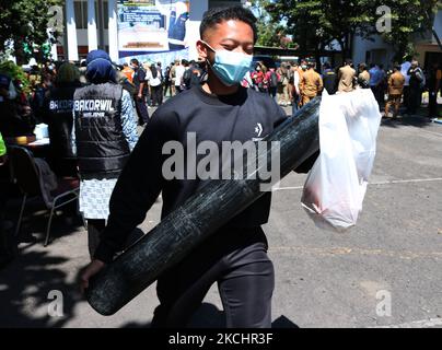 I lavoratori gestiscono bombole di ossigeno a carica libera presso il centro di distribuzione BPBD per i residenti esposti al coronavirus Covid-19 nel processo di auto-isolamento a casa a Malang, giava orientale, il 26 luglio 2021, poiché le forniture di ossigeno della nazione sono prioritarie verso i pazienti di coronavirus Covid-19, precedentemente per esigenze industriali (Foto di Aman Rochman/NurPhoto) Foto Stock