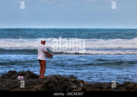 Uomo che pesca nell'Oceano Atlantico a Puerto Plata, Repubblica Dominicana, il 23 dicembre 2010. (Foto di Creative Touch Imaging Ltd./NurPhoto) Foto Stock