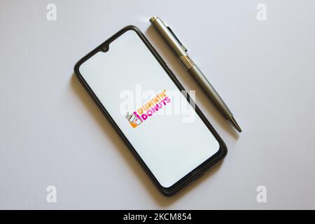 In questa foto, il logo Dunkin' Donuts viene visualizzato sullo schermo di uno smartphone e su una matita ad Atene, in Grecia, il 10 settembre 2021. (Foto di Nikolas Kokovlis/NurPhoto) Foto Stock