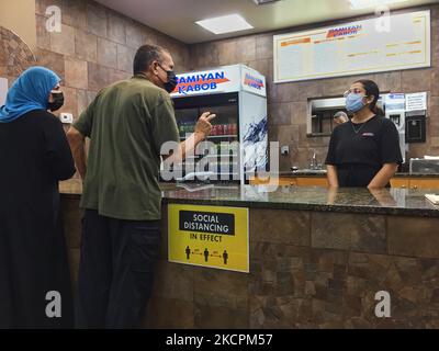 I patroni ordinano il cibo in un ristorante durante la pandemia del nuovo coronavirus (COVID-19) a Toronto, Ontario, Canada il 14 ottobre 2021. Tutti i residenti dell'Ontario che hanno almeno 12 anni sono già tenuti a mostrare una prova di vaccinazione (sotto forma di certificati di vaccino COVID-19) per cenare in ristoranti, nonché visitare palestre, cinema e altri ambienti interni ad alto rischio, tra cui luoghi per eventi sportivi e concerti. I membri del pubblico sono attualmente tenuti a mostrare una copia digitale o cartacea della loro ricevuta del vaccino COVID-19 per dimostrare che sono stati vaccinati completamente, con un vaccino con codice QR migliorato Foto Stock