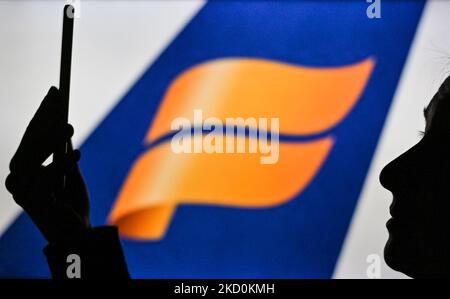 Immagine di una donna che tiene un telefono cellulare davanti al logo Icelandair Airline visualizzato sullo schermo di un computer. Martedì 12 gennaio 2021, a Edmonton, Alberta, Canada. (Foto di Artur Widak/NurPhoto) Foto Stock