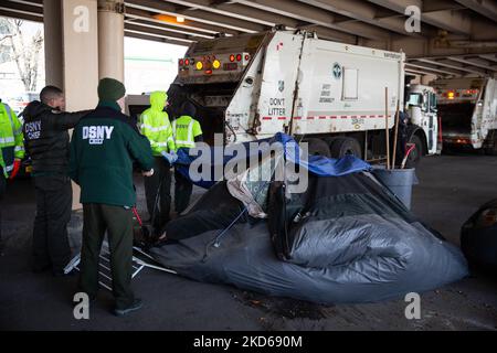 I lavoratori del Dipartimento di igiene sono accompagnati da NYPD mentre chiarono gli effetti personali di diversi newyorkesi senzatetto a Manhattan e Meeker Ave sotto la Brooklyn Queens Expressway a Brooklyn il 28 marzo 2022. (Foto di Karla Ann Cote/NurPhoto) Foto Stock