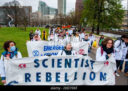 Come parte dell'organizzazione climatica Extinction Rebellion, gli scienziati marciano attraverso l'Aia durante la prima marcia di scienziato sul clima nei Paesi Bassi. Indossando camici da laboratorio, la marcia si è fermata davanti al Ministero delle Finanze, al Ministero dell'Economia e del clima e agli edifici del Ministero degli Affari Esteri, all'Aia, il 6th aprile 2022. (Foto di Romy Arroyo Fernandez/NurPhoto) Foto Stock