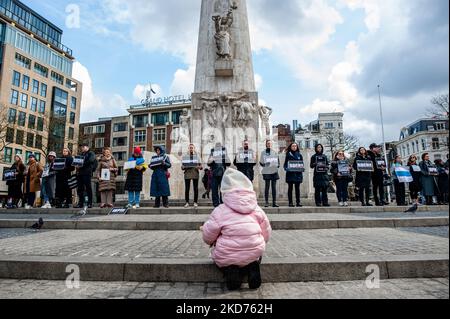 La gente sta tenendo cartelli con i nomi delle città ucraine attaccate dall'esercito russo, durante una veglia per le vittime della guerra in Ucraina, ad Amsterdam, il 9th aprile 2022. (Foto di Romy Arroyo Fernandez/NurPhoto) Foto Stock