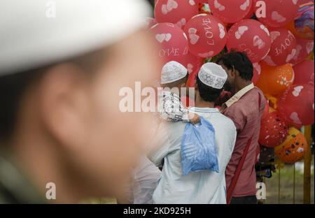 Un uomo musulmano che acquista palloncini per il suo bambino dopo aver pregato in un Eadgah per iniziare il festival Eid al-Fitr, che segna la fine del loro santo digiuno mese del Ramadan, a Guwahati, Assam, India il 03 maggio 2022. (Foto di David Talukdar/NurPhoto) Foto Stock