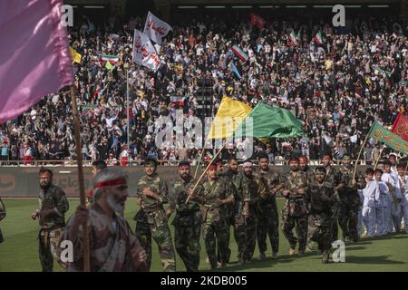 I membri della forza paramilitare iraniana Basij, che porta bandiere religiose, si esibiscono in un incontro a sostegno del leader supremo iraniano Ayatollah Ali Khamenei, presso lo stadio di calcio Azadi (Freedom) a ovest di Teheran, il 26 maggio 2022. Centomila sostenitori del leader supremo iraniano Ayatollah Ali Khamenei si sono riuniti nel complesso sportivo Azadi (Freedom) per cantare il Comandante Hello di Hymn. (Foto di Morteza Nikoubazl/NurPhoto) Foto Stock