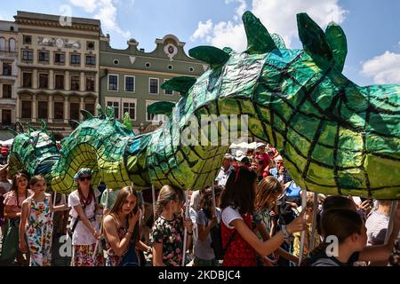 21st la Grande Parata del Drago si fa marciando nella piazza principale di Cracovia, Polonia, il 5th giugno 2022. La sfilata annuale del Grande Drago comprende più di mille partecipanti, per lo più bambini, che partecipano al colorato evento pieno di varie creature di drago preparate da soli. (Foto di Beata Zawrzel/NurPhoto) Foto Stock