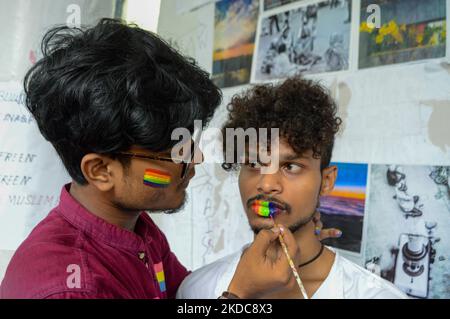 I partecipanti sono visti disegnare colori arcobaleno l'uno sull'altro faccia durante un rally di orgoglio a Kolkata , in India , il 18 giugno 2022 . La comunità LGBTQ e le varie organizzazioni studentesche hanno tenuto una marcia d'orgoglio per celebrare il mese d'orgoglio a Kolkata . (Foto di Debarchan Chatterjee/NurPhoto) Foto Stock