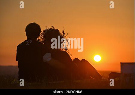 Una coppia che guarda l'alba accanto al tumulo di Cracovia a Cracovia. Sabato 25 giugno 2022, nella piazza principale del mercato, Cracovia, Polonia. (Foto di Artur Widak/NurPhoto) Foto Stock