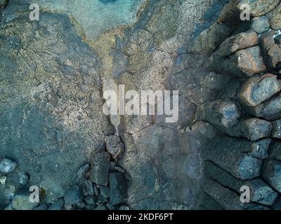 Abstract rocce vulcaniche veduta aerea dell'Oceano Atlantico in Caleta de Fuste Fuerteventura isola fotografia drone Foto Stock