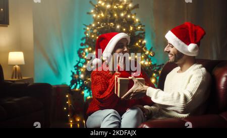 Boy surprises his girlfriend with Christmas present Foto Stock