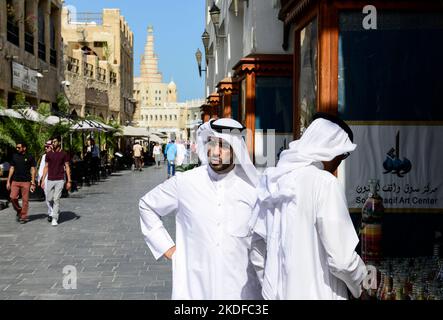 QATAR, Doha, bazar Souq Waqif e Fanar, dietro la torre del Qatar Islamic Culture Center, qatar man a Thwab / KATAR, Doha, Basar Souk Wakif und Moschee und FANAR (Qatar Islamic Cultural Center), Männer tragen ein langes Weißes Gewand, Thawb, und einen weißen Kopfschutz, Ghitra mit iwarem Band, Ghitra festgehalten wird Foto Stock