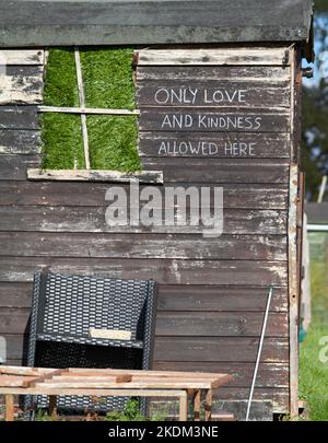 Vecchia scogliera di legno in un Allotment con il messaggio motivante positivo 'solo amore e gentilezza permesso qui' dipinta sul lato, Inghilterra UK Foto Stock