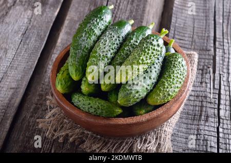 Cetrioli freschi nella ciotola di legno. Cibo vegetariano Foto Stock