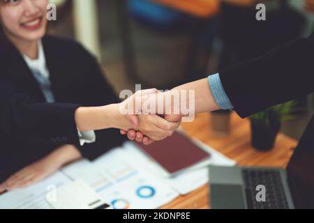 Gli imprenditori asiatici si congratulano con l'accordo tra le due aziende per aumentare gli investimenti e la forza finanziaria. Concetto di trattativa Foto Stock