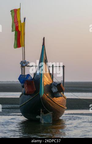 Vista frontale di una bella tradizionale barca da pesca in legno conosciuta come barche sulla luna sulla spiaggia vicino a Cox's Bazar nel sud del Bangladesh al tramonto Foto Stock