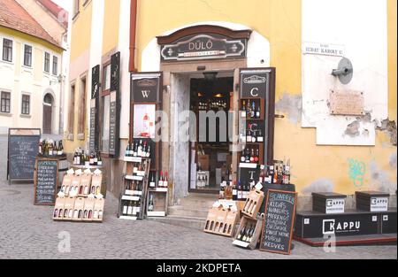 Esposizione di vini in vendita al di fuori di un venditore di vino tradizionale, Eger, Ungheria Foto Stock