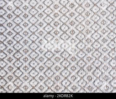 Primo piano con tappeto a maglia grigio. Sfondo dettagliato da filato caldo. Tessuto di lana naturale. Il tappetino è privo di pelucchi. Materiale ecologico Foto Stock