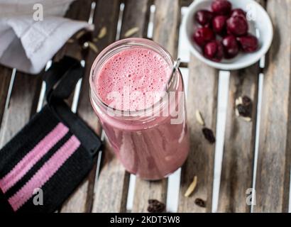 Prima dell'allenamento, agitare le proteine con siero di latte, ciliegie acide per carboidrati complessi, mandorle e uvetta Foto Stock