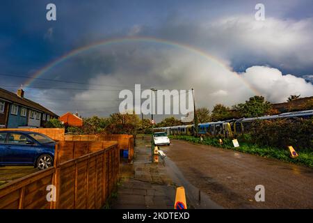 Un arcobaleno si forma su cieli oscuri a Twickenham, Londra, dopo una pesante doccia a pioggia. Il Regno Unito ha vissuto la pioggia e i venti alti, con un avvertimento di tempo giallo emesso per parti del paese. Foto Stock