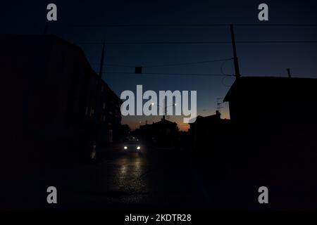 Attraversamento ferroviario in una città al crepuscolo Foto Stock