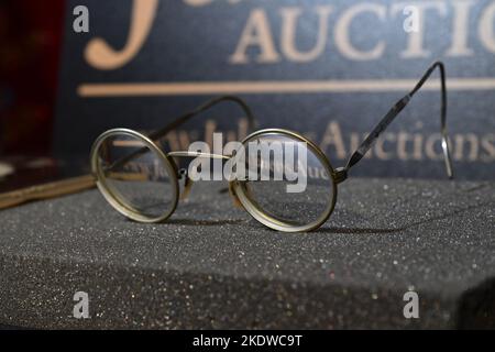 Un paio di occhiali tondi in tonalità oro con filo metallico abbinato a foto, di proprietà e indossati da John Lennon, in mostra all'Hard Rock Cafe Times Square il 08 novembre 20 Foto Stock