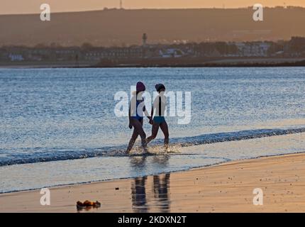 Portobello, Edimburgo, Scozia, Regno Unito. 9th novembre 2022. Nuvoloso sorgere del sole alla temperatura del Firth of Forth a 10 gradi centigradi per Sasha e Agnes dopo il loro bagno giornaliero di acqua fredda prima di partire per il loro lavoro di giorno. Credit: Arch White/alamy live news Foto Stock