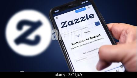 San Francisco, USA, giugno 2022: Tenere un telefono con Zazzle homepage sullo schermo. Logo Zazzle sfocato su sfondo blu. Zazzle è un'America Foto Stock