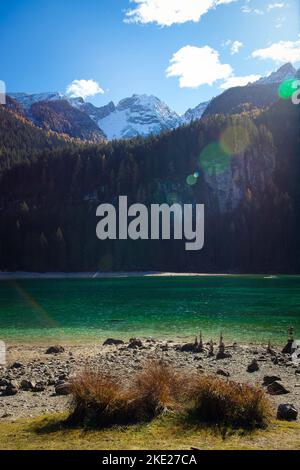 Vista autunnale sul lago di Tovel, Trentino Alto Adige, Italia. Scatto verticale con luce solare. Foto Stock