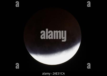 Melbourne, Victoria, Australia. 8th Nov 2022. La luna di sangue è vista durante un'eclissi lunare totale a Digger Rest Melbourne, Australia, il 08 novembre 2022. Il martedì sera la gente attraverso l'Australia e la Nuova Zelanda ha potuto vedere un'eclissi lunare totale. La prossima serie di eclissi lunari dopo questa sarà visibile da questa regione il 14 marzo 2025 secondo la NASA. Un'eclissi lunare accade quando la luna viaggia attraverso l'ombra della Terra. La Terra impedisce alla luce solare di raggiungere la Luna, e invece la luce si piega attraverso l'atmosfera della Terra, gettando una tonalità rossastra sulla Luna Foto Stock