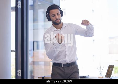 Uomo d'affari, cuffie e danza audio motivazione in ufficio per la libertà o la felicità. Uomo, musica e ascoltare podcast online in azienda Foto Stock