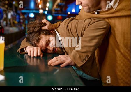 Uomo aggressivo che tira il ragazzo sul bancone del bar Foto Stock