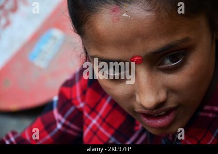 Faccia della ragazza nepalese che posa ritratto tra l'uso hennè inchiostro scrivere disegno pittura mehndi hennè tatuaggio come body art modello a mano del viaggiatore in thamel ol Foto Stock