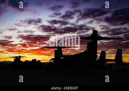 Il sole sorge dietro un V-22 Osprey, prima che arrivino le folle, al Miramar Airshow 2022 a San Diego, California. Foto Stock