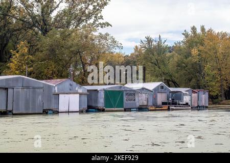 Fila di vecchie case di barche in alluminio o acciaio sull'isola di Latsch nelle acque posteriori del fiume Mississippi a Winona, Minnesota USA. Foto Stock