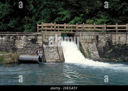 Il 2 luglio 2005, un ragazzo solista pesca presso il canale di versamento al Roaring River state Park vicino a Cassville, Missouri. Roaring River è una delle acque fredde del Missouri Foto Stock