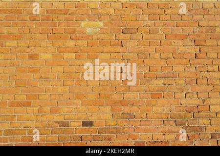 Muro di pietra di sabbia. Muro di mattone sabbia-colorato Foto Stock